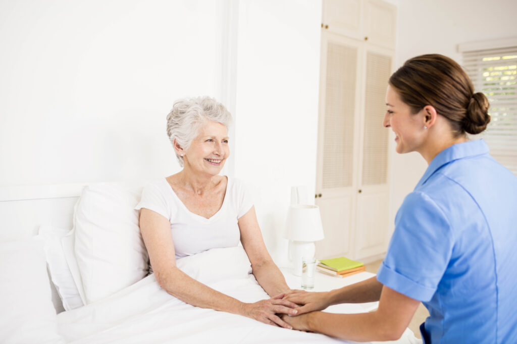 Nurse taking care of suffering senior patient at home